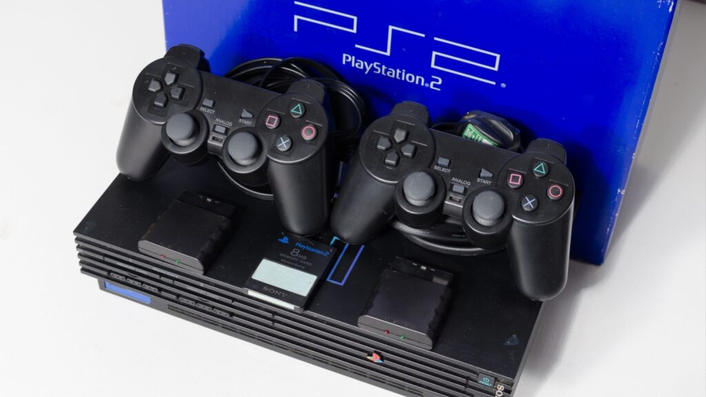 london, england, 07.05.2020 An original black sony playstation 2 console with games and controls. PS2 retro video game console. clean immaculate vintage console. Sonys game hardware unit isolated