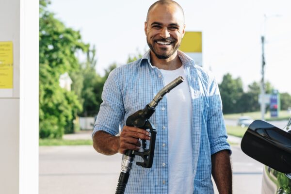 Man filling gasoline fuel in car at gas station