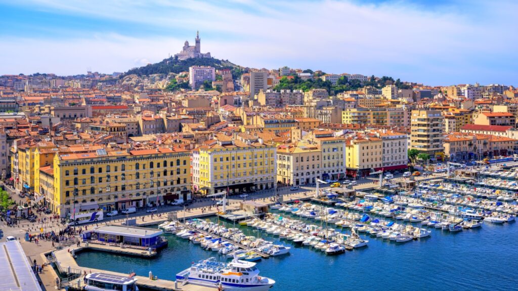 The old Vieux Port and Basilica Notre Dame de la Garde in the historical city center of Marseilles, France