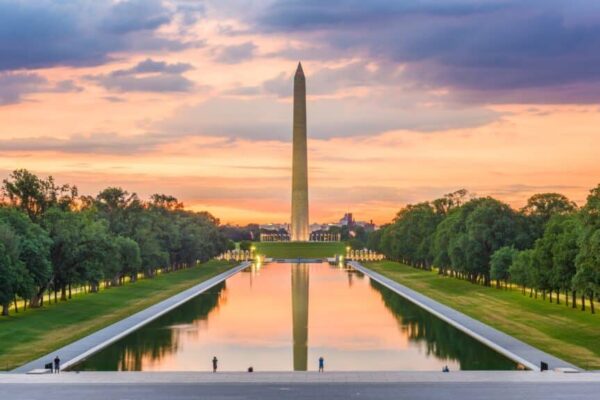 Washington Monument on the Reflecting Pool in Washington, DC, USA at dawn.