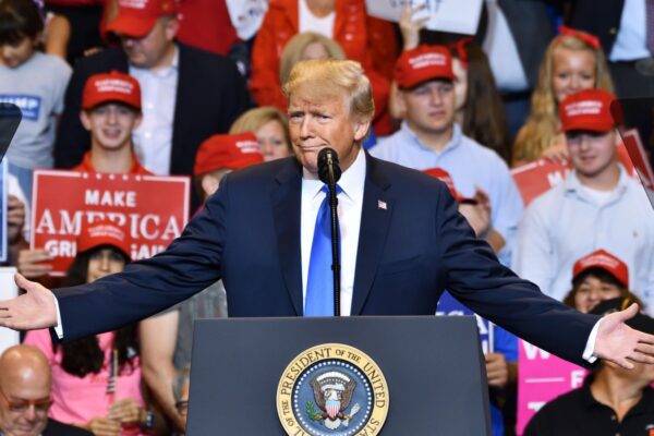 WILKES-BARRE, PA - AUGUST 2, 2018: President Donald Trump gestures "can you believe this" with wide open hands at a campaign rally for Congressman Lou Barletta.