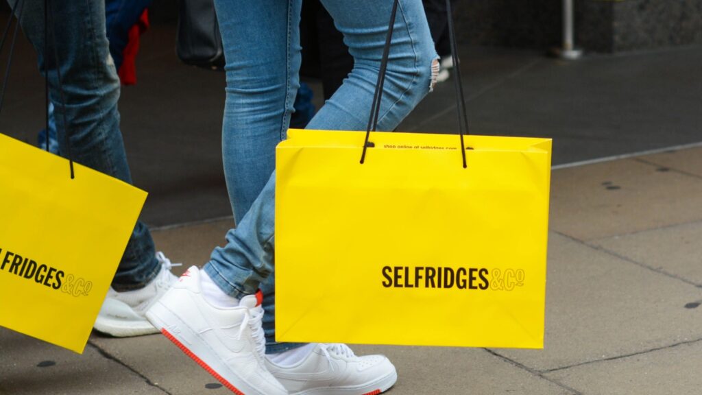 London, UK, June 25, 2019: Shoppers carrying Selfridges bags