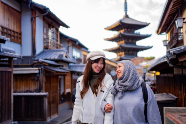 Travel, muslim travel, woman girl tourist Two Asian friends but different religions walking at Yasaka Pagoda and Sannen Zaka Street in Kyoto Japan, Yasaka
