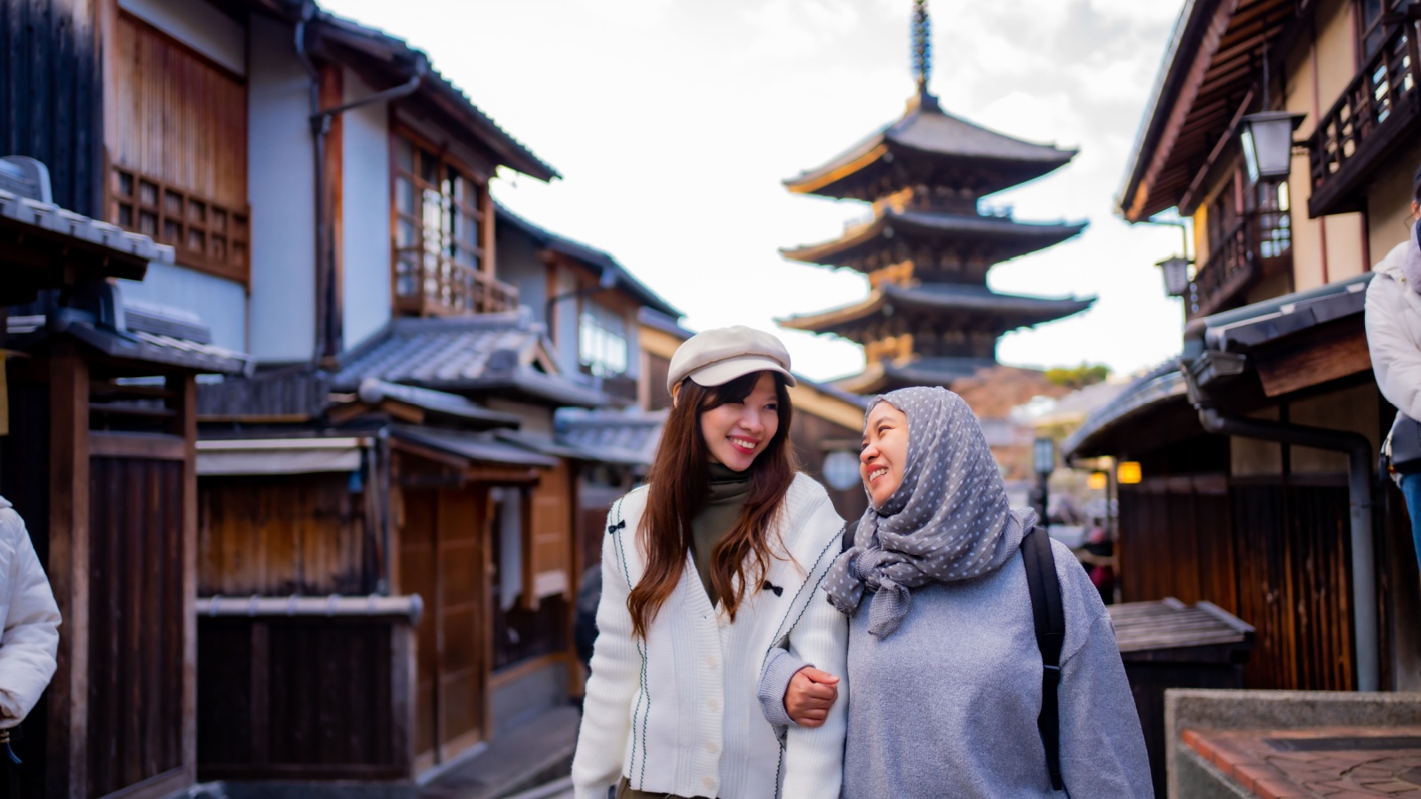 Travel, muslim travel, woman girl tourist Two Asian friends but different religions walking at Yasaka Pagoda and Sannen Zaka Street in Kyoto Japan, Yasaka