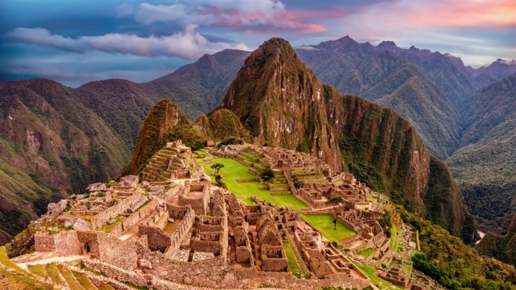 View of the lost inca city Machu Picchu, agriculture terraces at sunset. Peru