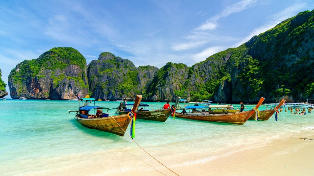 Maya bay 20 11 2011 beach withtraditional wooden longtail boat and blue sky in Maya bay, Thailand. Vacation holidays summer background. View of nice tropical beach in Maya bay near Phuket in Thailand.