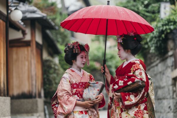 Maiko geisha walking on a street of Gion in Kyoto Japan