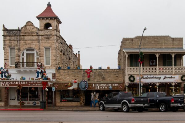 Fredericksburg, TX - USA - December `10 2019: Exterior of businesses on main street, including Headquarters Hats and Fredericksburg Jewelers