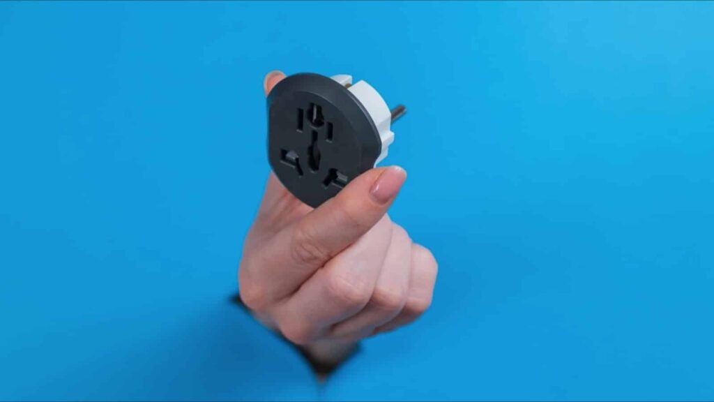 Hand holding outlet adapter