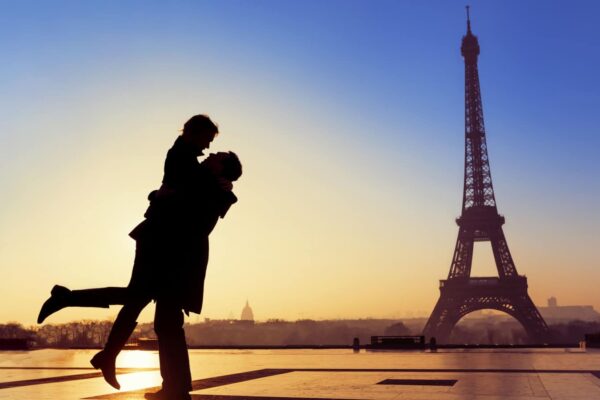 Couple kissing under the eiffel tower in paris france