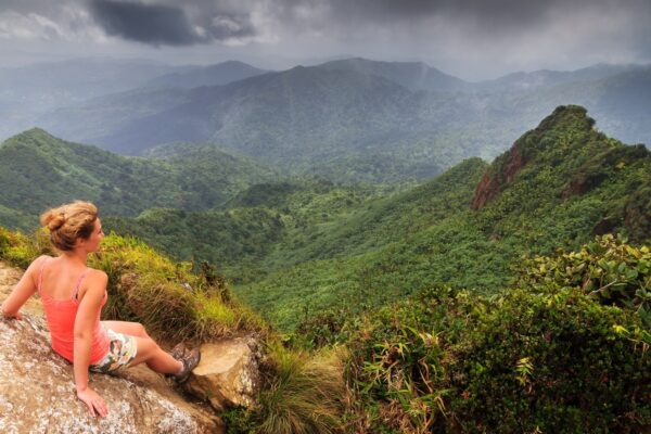 Adventurous young woman on top of the beautiful jungle of the El Yunque national forest in Puerto Rico