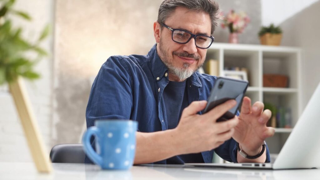 Man-using-mobile-having-coffee