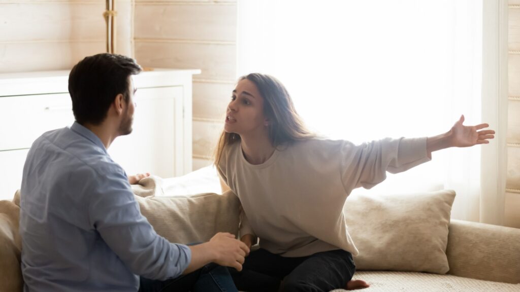 Misunderstanding. Angry worried young spouses quarreling arguing at home, annoyed nervous millennial wife shouting screaming on frustrated husband accusing in cheat threatening with breakup divorce