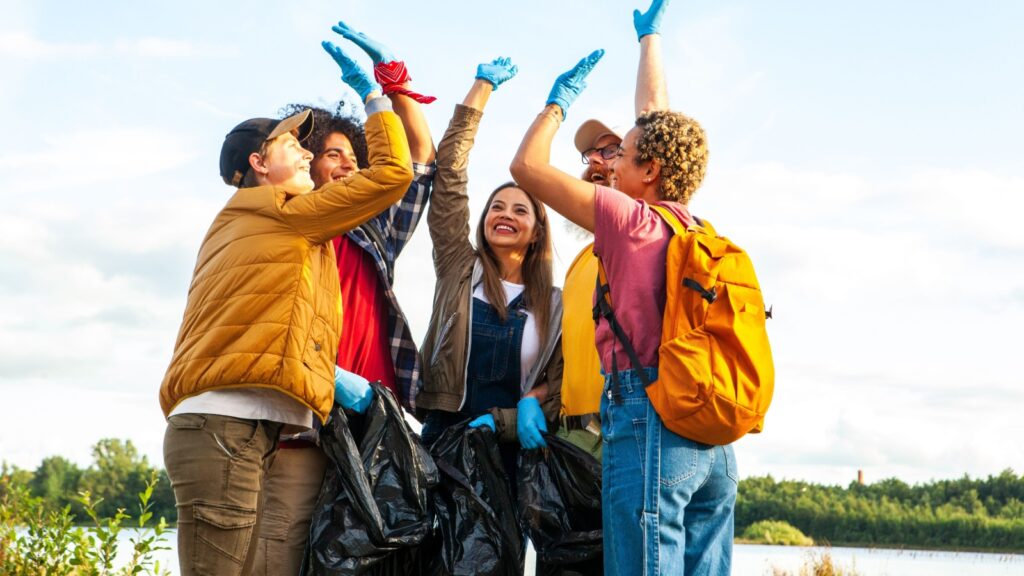 Celebrate the spirit of environmental stewardship and camaraderie in this dynamic image. A diverse group of young volunteers from different ethnic