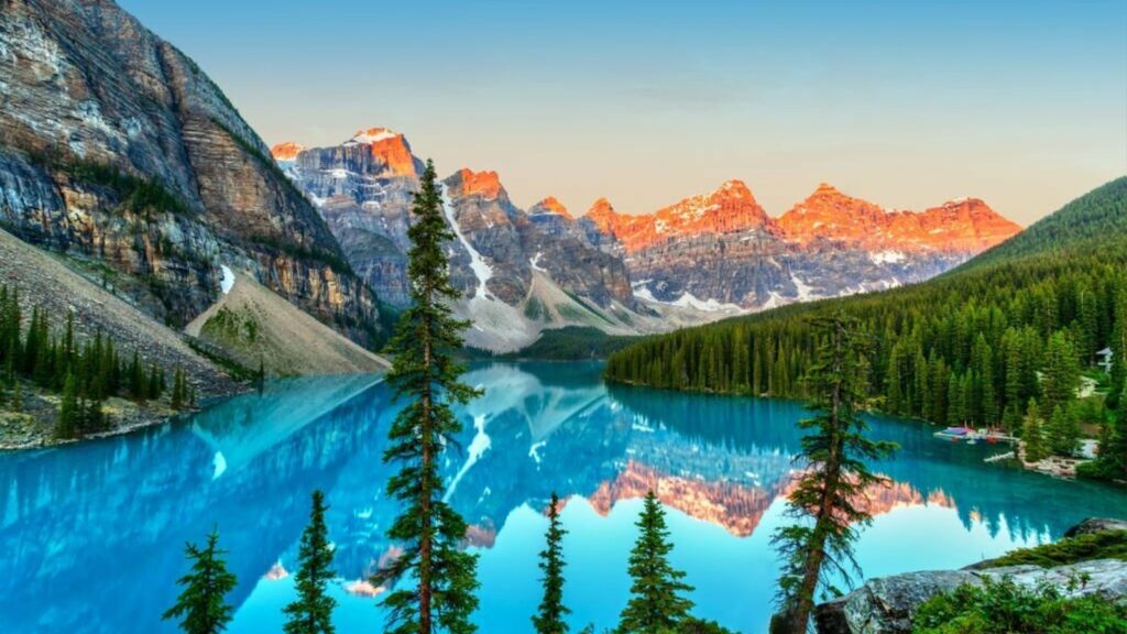 Golden sunrise over the Valley of the Ten Peaks with glacier-fed turquoise-colored Moraine Lake in the foreground near Lake Louise in the Canadian Rockies of Banff National Park.