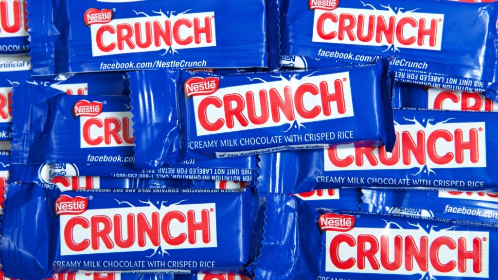 Alameda, CA - Oct 13, 2020: Top view flat lay of many Nestle Crunch bars, fun sized minis. Perfect for Halloween treat giving.