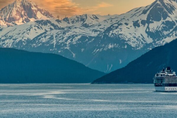 Cruise Ship sailing on the inside passage near Skagway near the Alaskan mountain range.