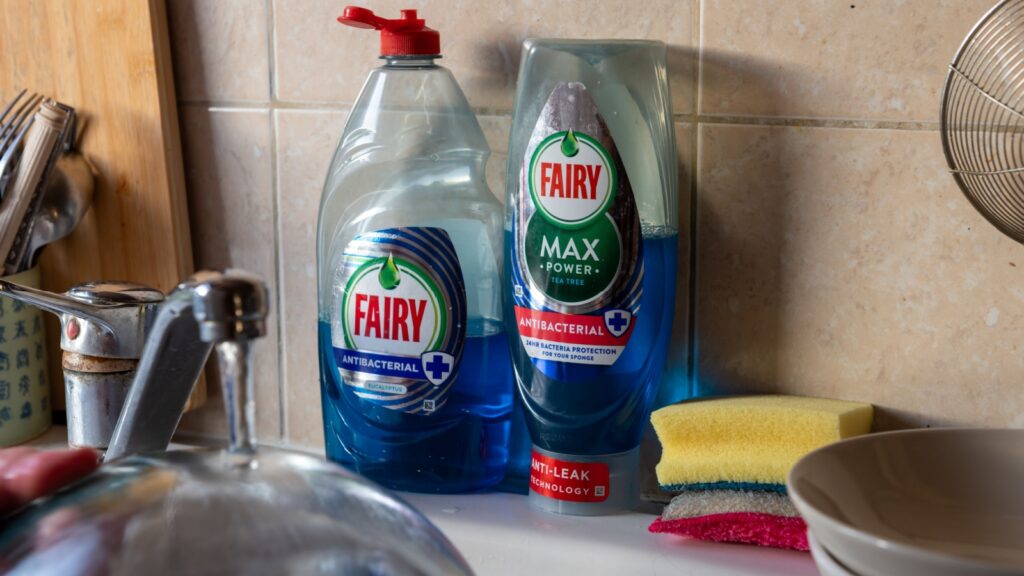 London. UK- 12.07.2022. A bottle of Fairy Max and Fairy antibacterial washing up liquid by a kitchen sink.