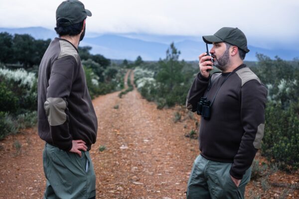 Team of Park Rangers with uniform using Walkie Talkie radio to monitor wildlife in the nature reserve