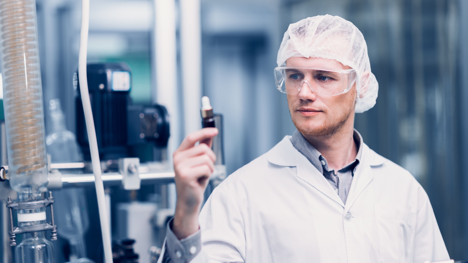 Scientist in Science Lab proudly invented New Medicine Formula. Medical factory staff happy smiling with Concentrate Medical Extract from Plant.