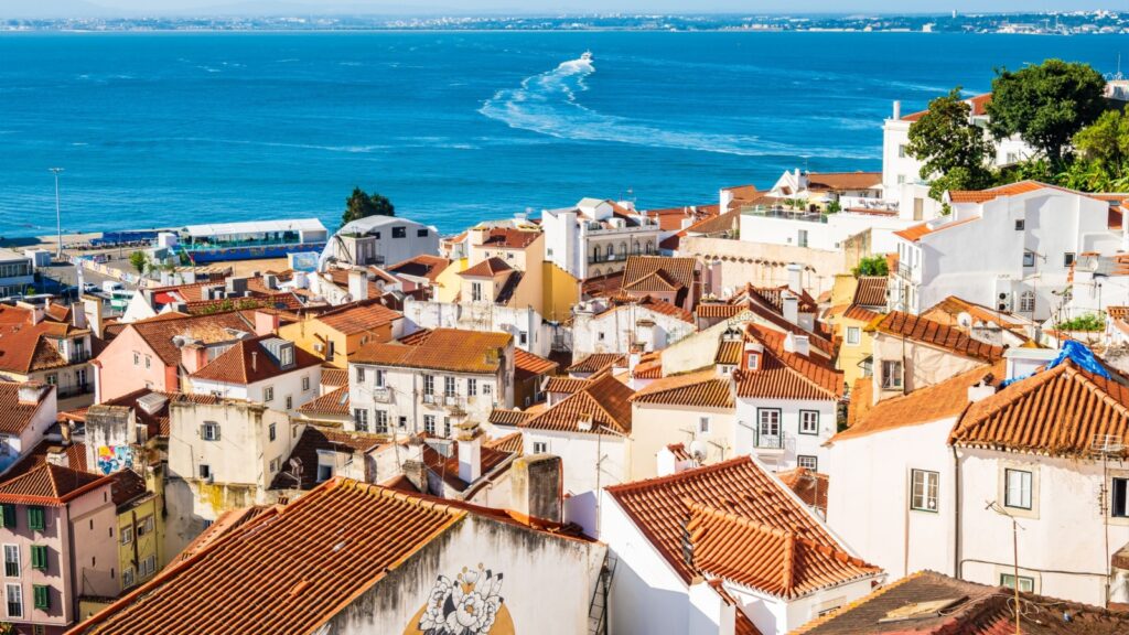 View of Lisbon old town Alfama district with houses clay orange roofs from viewpoint Portas do Sol, Lisbon, Portugal