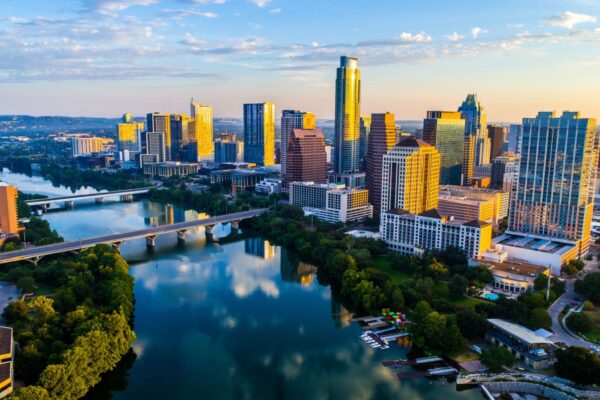 Austin Texas USA sunrise skyline cityscape over Town Lake or Lady Bird Lake with amazing reflection. Skyscrapers and Texas capital building in distance you can see the entire city during summer