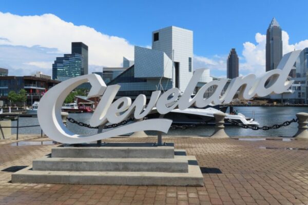 Cleveland, OH USA June 24 2024: Large script sign for Cleveland with skyscraper buildings in the background in Cleveland Ohio